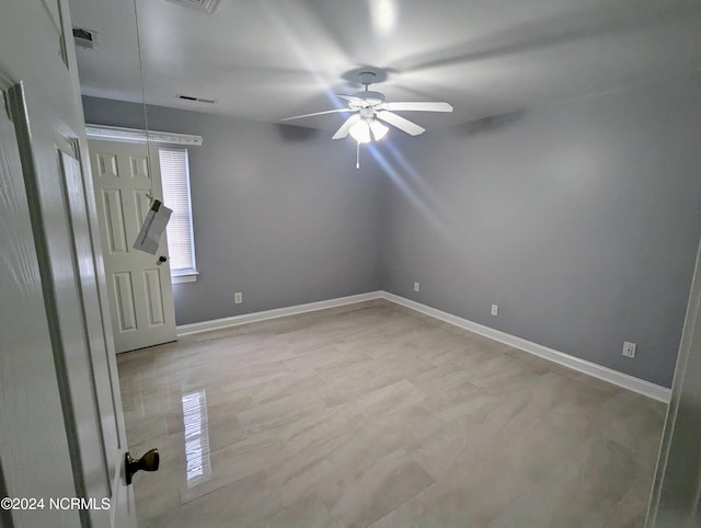 unfurnished room with ceiling fan