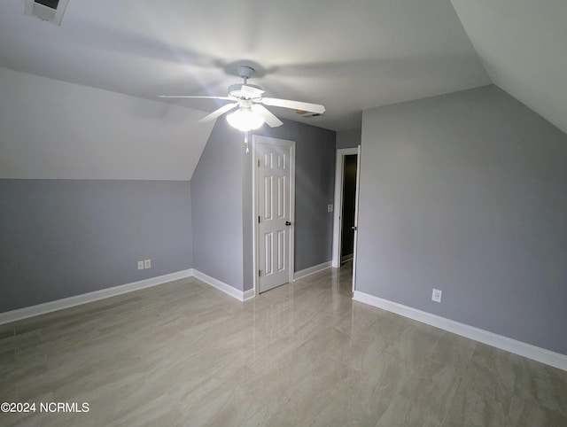 additional living space featuring vaulted ceiling and ceiling fan