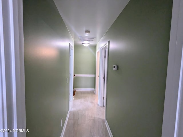 hallway with light hardwood / wood-style flooring