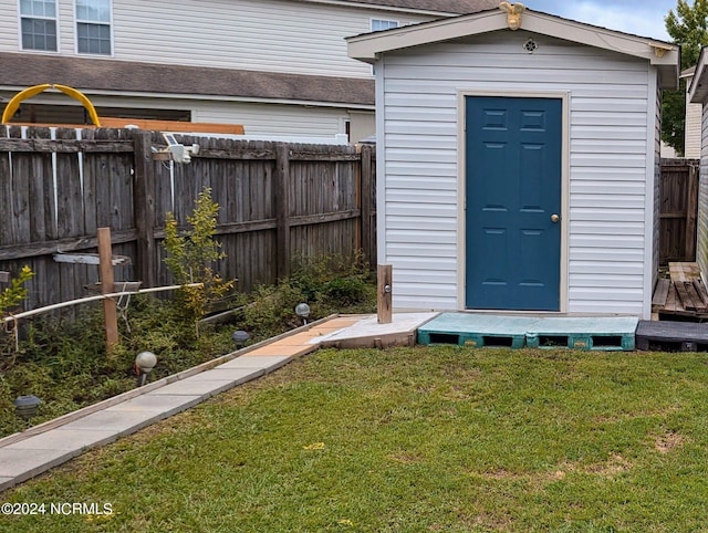 view of outdoor structure with a lawn