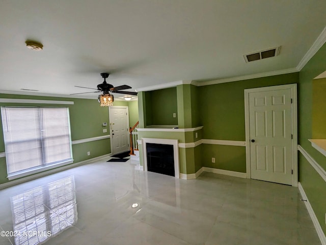 unfurnished living room with ceiling fan and crown molding