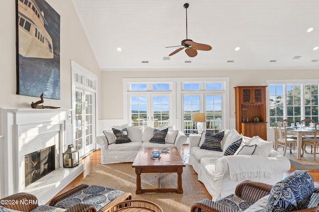 living room featuring french doors, a premium fireplace, plenty of natural light, and ceiling fan