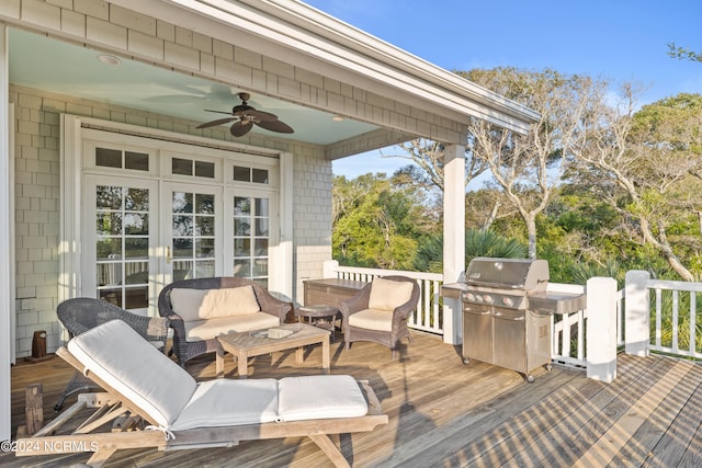 wooden deck with french doors, grilling area, and ceiling fan