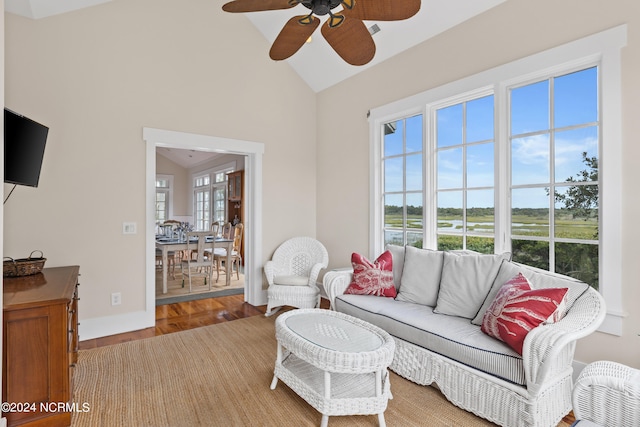 living room with lofted ceiling, ceiling fan, and light hardwood / wood-style flooring