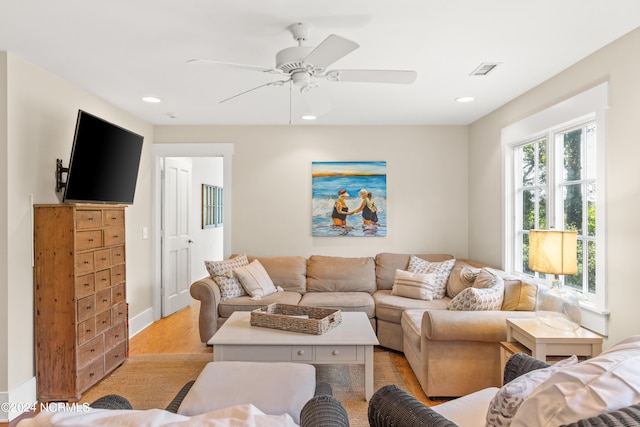 carpeted living room featuring ceiling fan