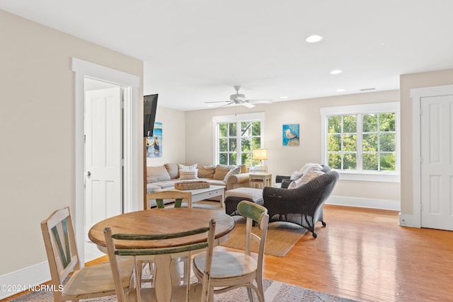 dining room featuring ceiling fan, light hardwood / wood-style flooring, and a wealth of natural light