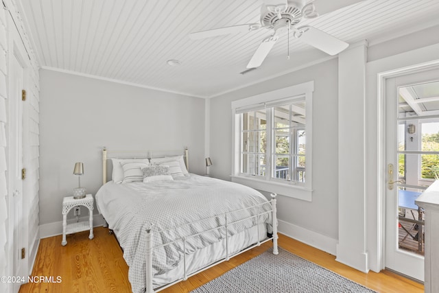 bedroom with ceiling fan, wood ceiling, crown molding, and hardwood / wood-style floors