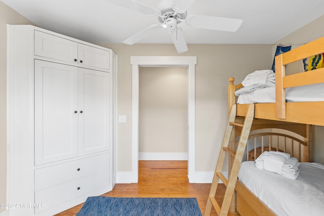 bedroom featuring ceiling fan, light wood-type flooring, and a closet