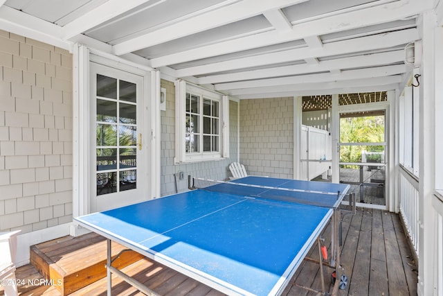 recreation room with beamed ceiling and dark hardwood / wood-style floors