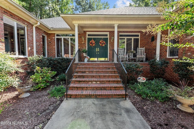 doorway to property featuring covered porch