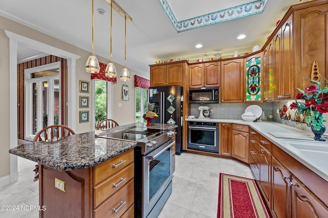 kitchen featuring ornamental molding, a kitchen island, hanging light fixtures, black oven, and stainless steel electric stove