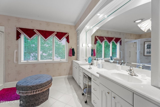 bathroom with a shower stall, wallpapered walls, double vanity, ornamental molding, and a sink