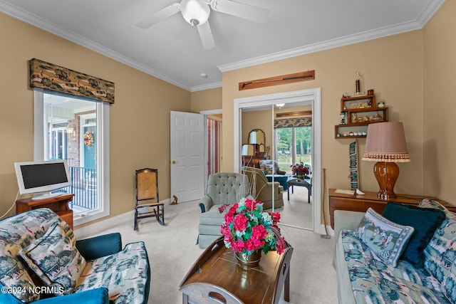 carpeted living room featuring ornamental molding and ceiling fan