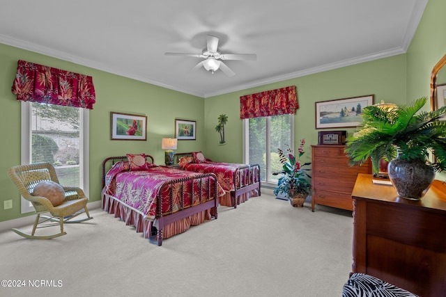 carpeted bedroom with ceiling fan and ornamental molding