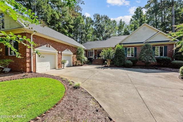 view of front of home featuring a garage and a front lawn