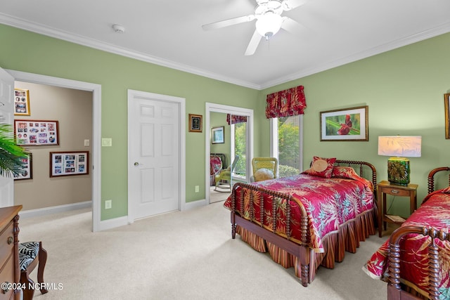 carpeted bedroom with ornamental molding and ceiling fan