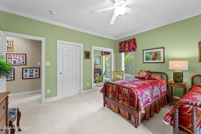 carpeted bedroom featuring baseboards, crown molding, and ceiling fan