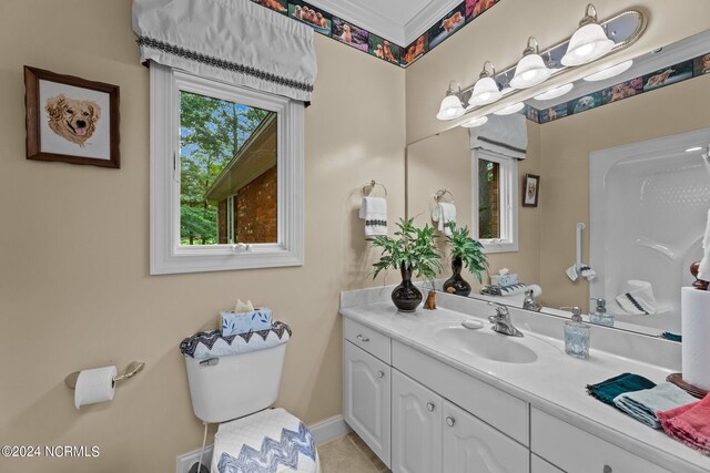 bathroom with tile patterned flooring, toilet, vanity, and baseboards