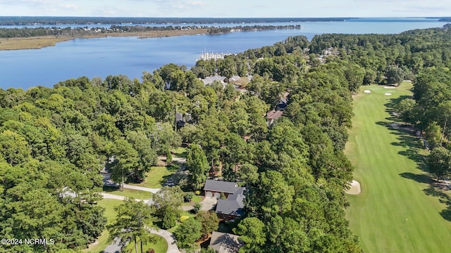 drone / aerial view with a forest view, golf course view, and a water view