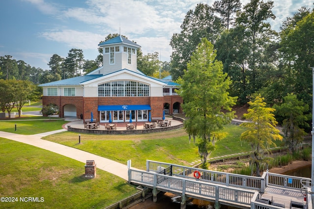 view of community with a deck and a yard