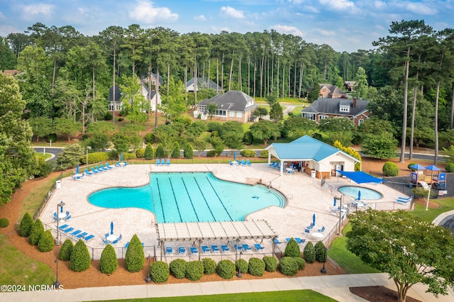 pool featuring fence and a patio area