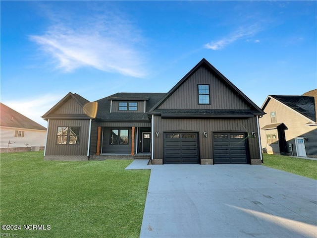 view of front of house with a garage and a front lawn