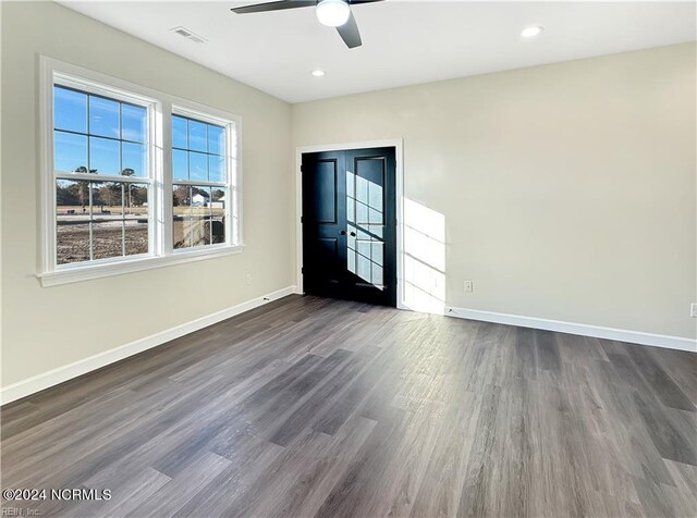 interior space with ceiling fan and dark hardwood / wood-style floors