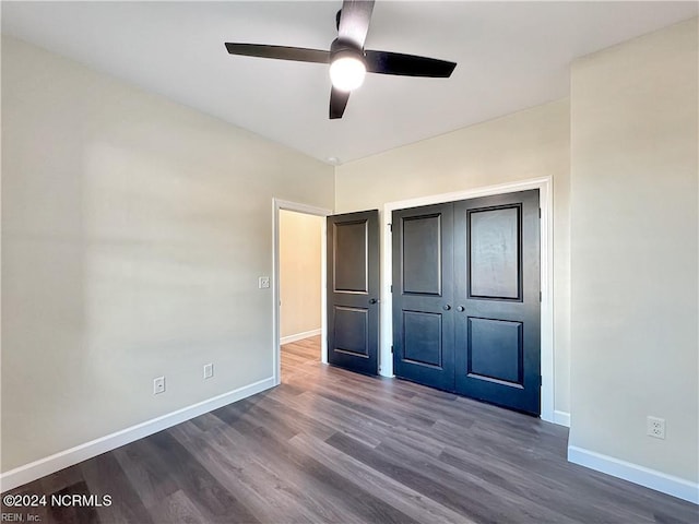 unfurnished bedroom featuring ceiling fan, a closet, and dark hardwood / wood-style flooring