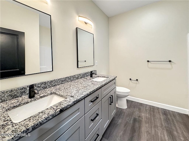 bathroom featuring hardwood / wood-style floors, vanity, and toilet