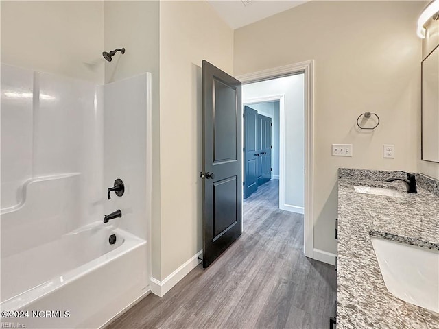 bathroom featuring shower / bathing tub combination, hardwood / wood-style flooring, and vanity