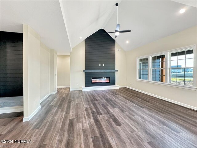 unfurnished living room with wood-type flooring, a fireplace, lofted ceiling, and ceiling fan