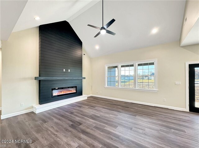 unfurnished living room with ceiling fan, a fireplace, hardwood / wood-style floors, and high vaulted ceiling