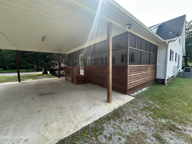 view of home's exterior featuring a sunroom and a lawn