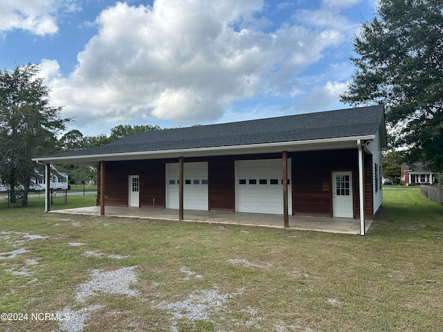 garage with a lawn and a carport