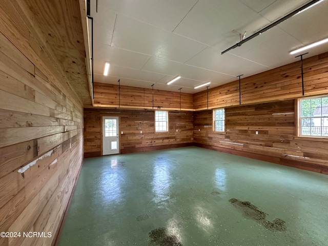 interior space with a healthy amount of sunlight and wood walls