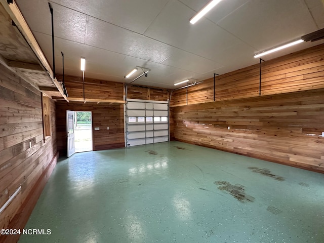 garage featuring wooden walls