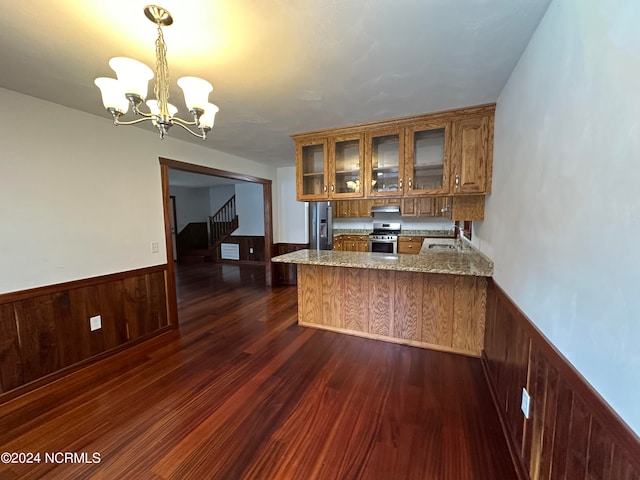 unfurnished room featuring ceiling fan, wooden walls, and dark hardwood / wood-style flooring