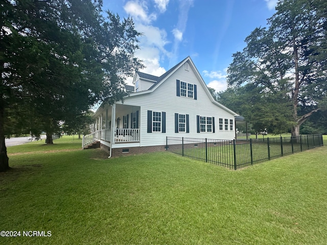 rear view of house featuring a lawn