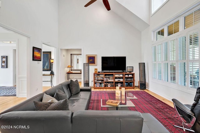 79 Bishop Branch Ln SE, Leland, NC 28451 - living room featuring a high ceiling, wood finished floors, a ceiling fan, plenty of natural light, and baseboards