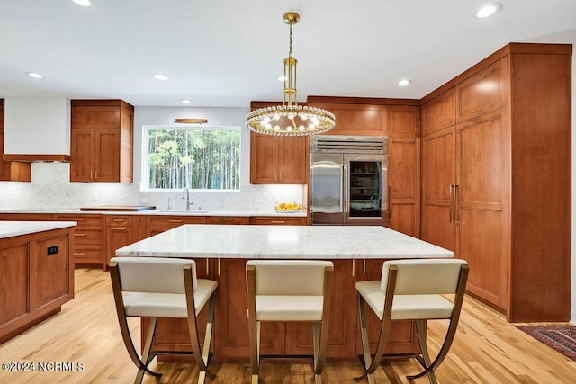 79 Bishop Branch Ln SE, Leland, NC 28451 - kitchen featuring built in refrigerator, a sink, light wood-type flooring, tasteful backsplash, and recessed lighting