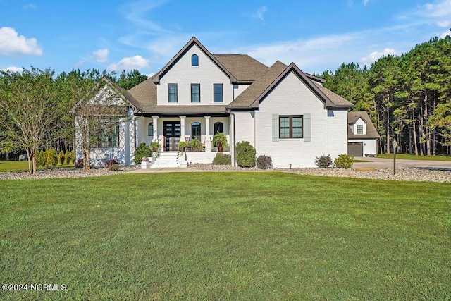 79 Bishop Branch Ln SE, Leland, NC 28451 - view of front of home featuring a porch, a front lawn, brick siding, and a shingled roof