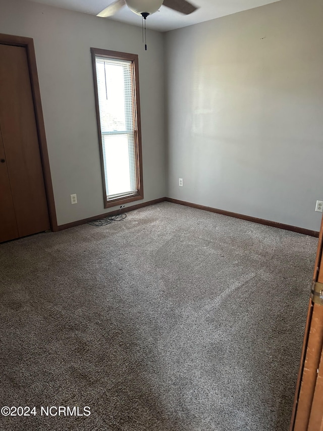 spare room with carpet and ceiling fan