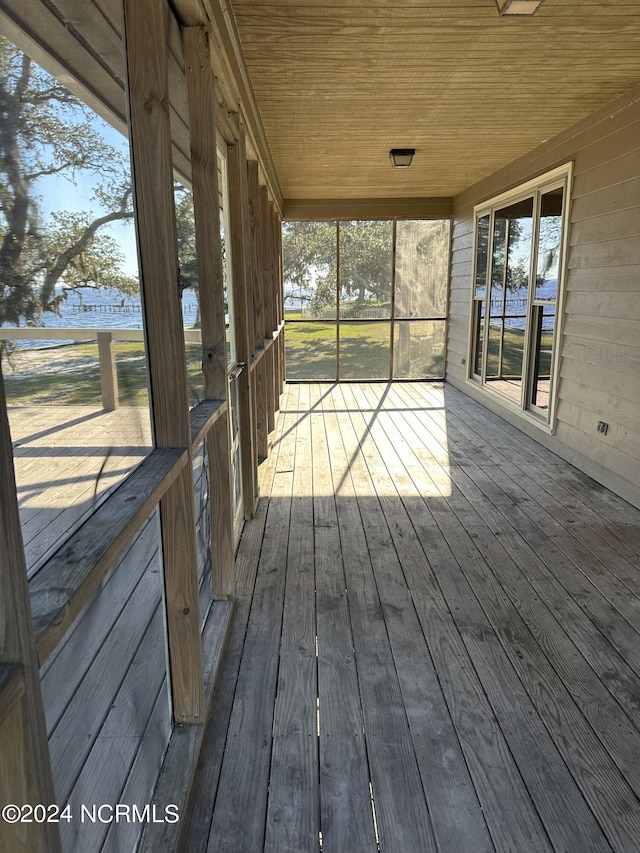 unfurnished sunroom with wood ceiling