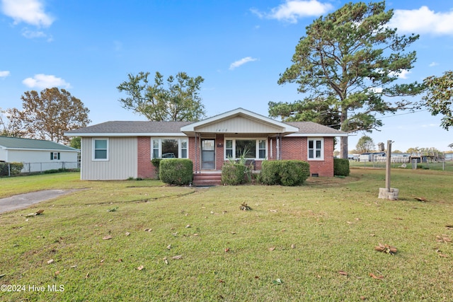 single story home featuring a front lawn and covered porch