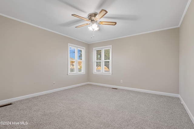 spare room with carpet flooring, ceiling fan, and crown molding