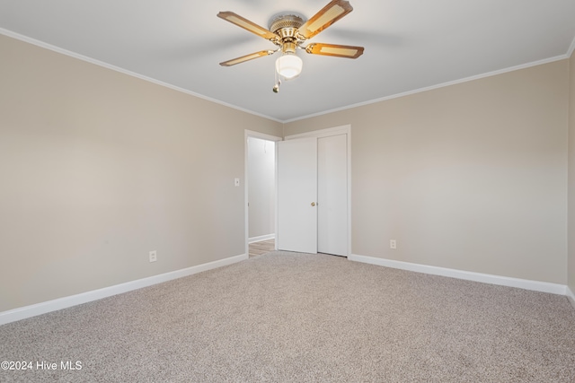 spare room featuring carpet floors, ceiling fan, and crown molding