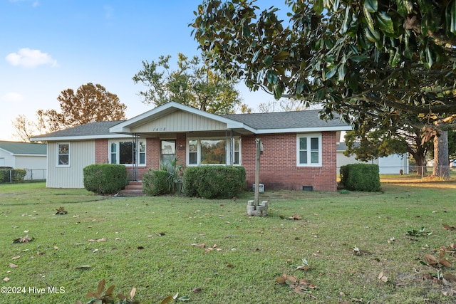 ranch-style home with a front lawn