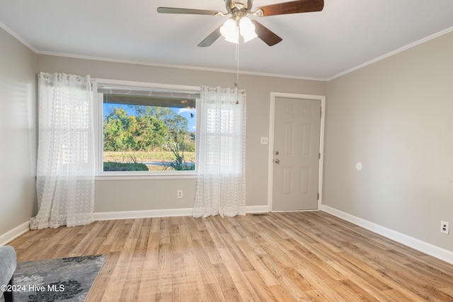 unfurnished room with ceiling fan, light hardwood / wood-style flooring, and ornamental molding