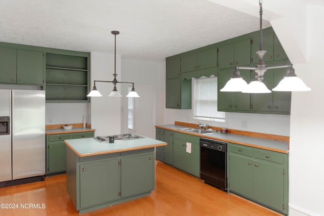 kitchen with light hardwood / wood-style flooring, stainless steel appliances, green cabinets, and a center island