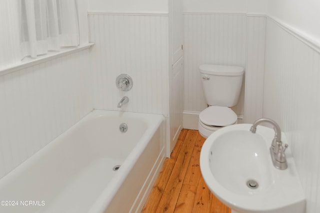 bathroom featuring wood-type flooring and toilet